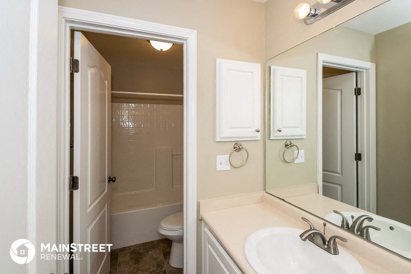 a bathroom with a sink and a mirror and a toilet