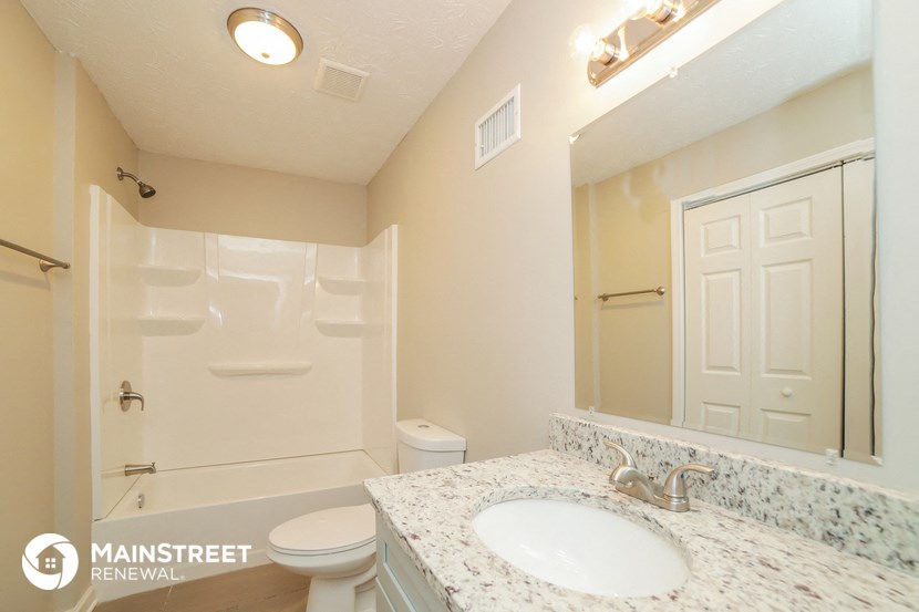 a bathroom with a sink and a toilet and a shower