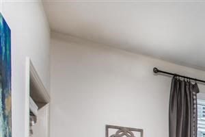 Select homes feature wood-look flooring in the living spaces a living room with a couch and a ceiling fan