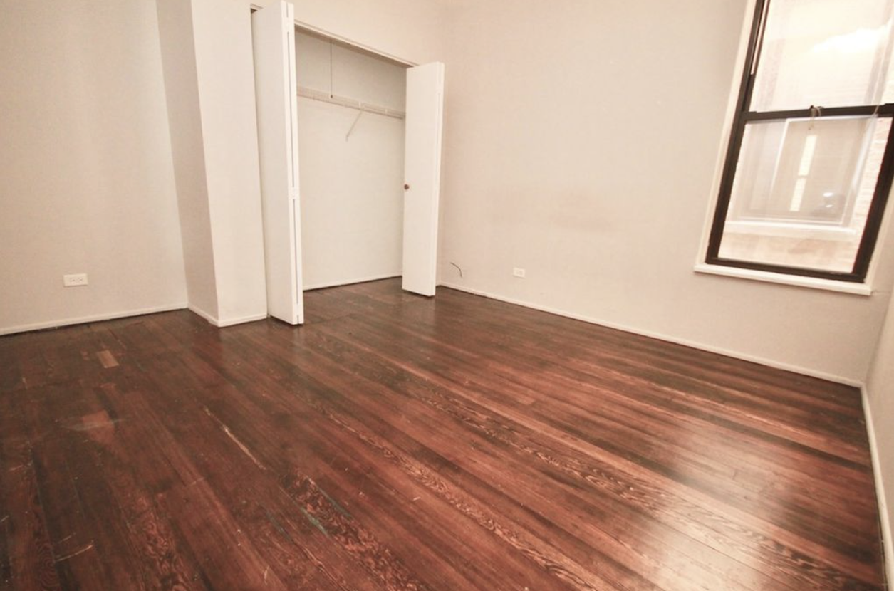 Bedroom with hard-wood flooring