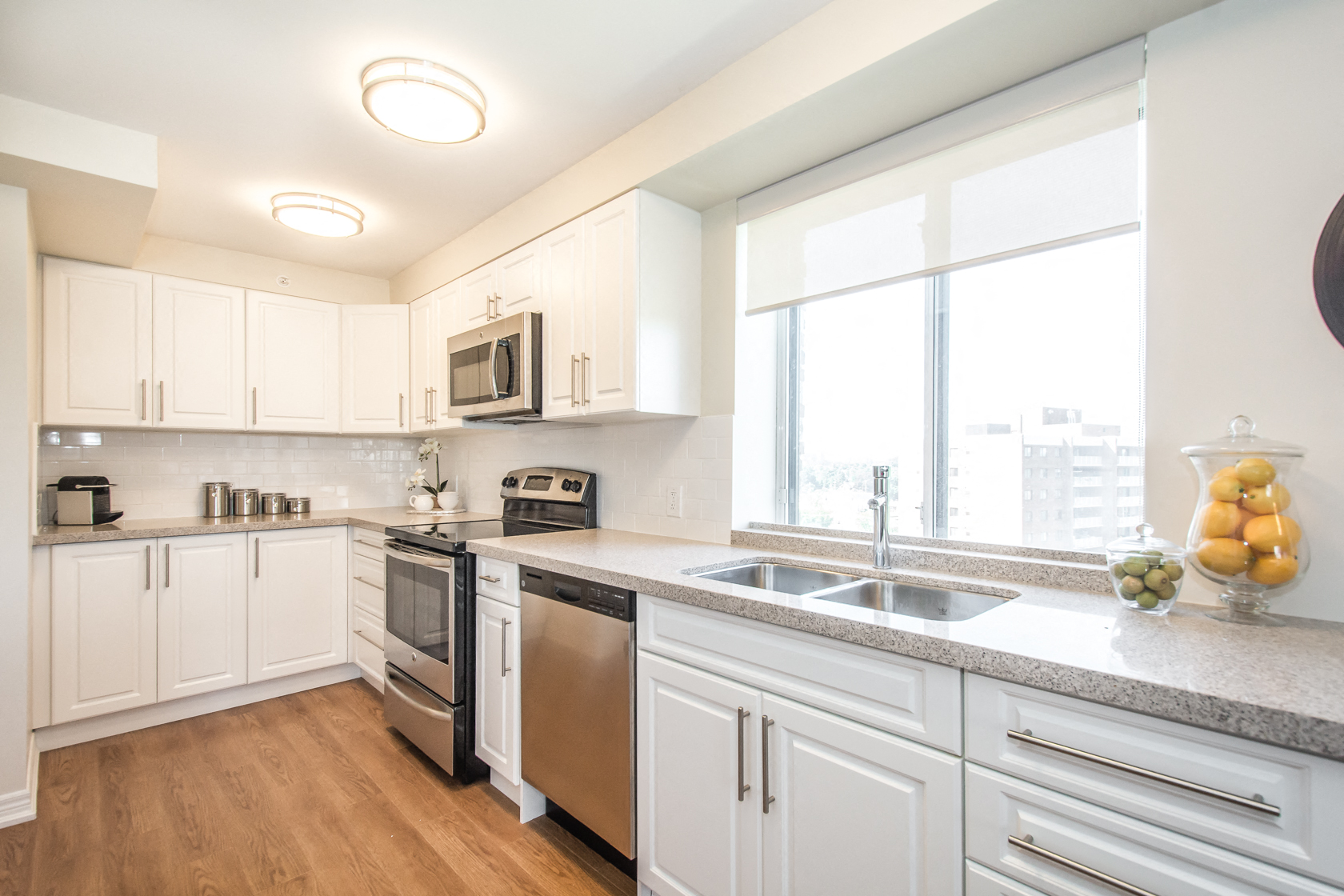 A kitchen with white cabinets and stainless steel appliances.