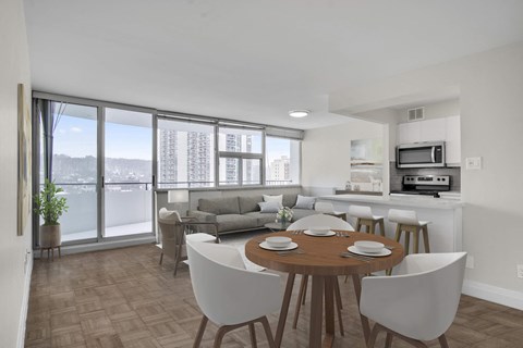 A dining room with a table set for six with a view of the city.
