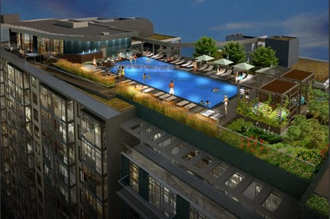 A rooftop pool with people in it.
