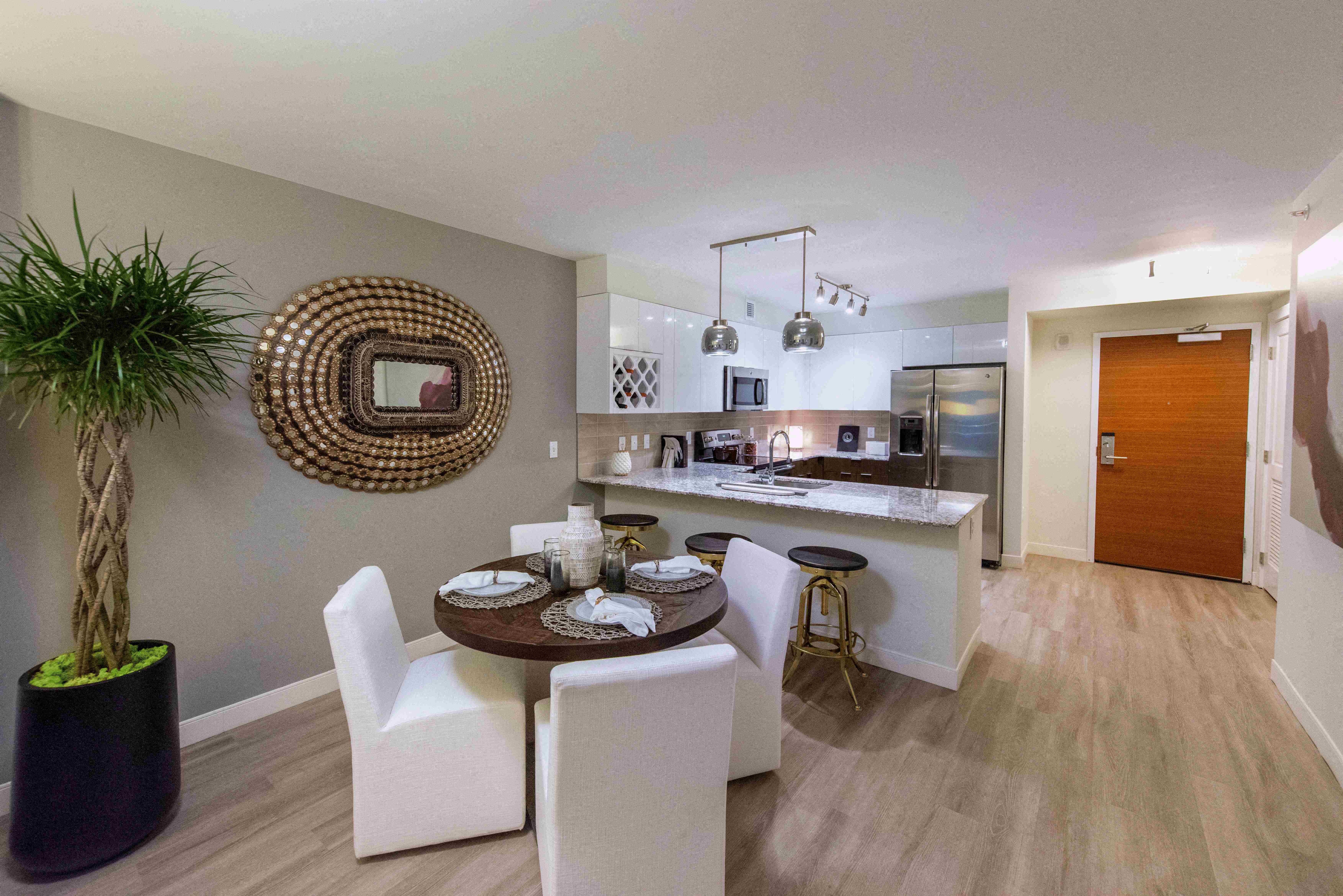a kitchen and dining room with a table and chairs