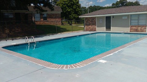 a swimming pool in front of a house