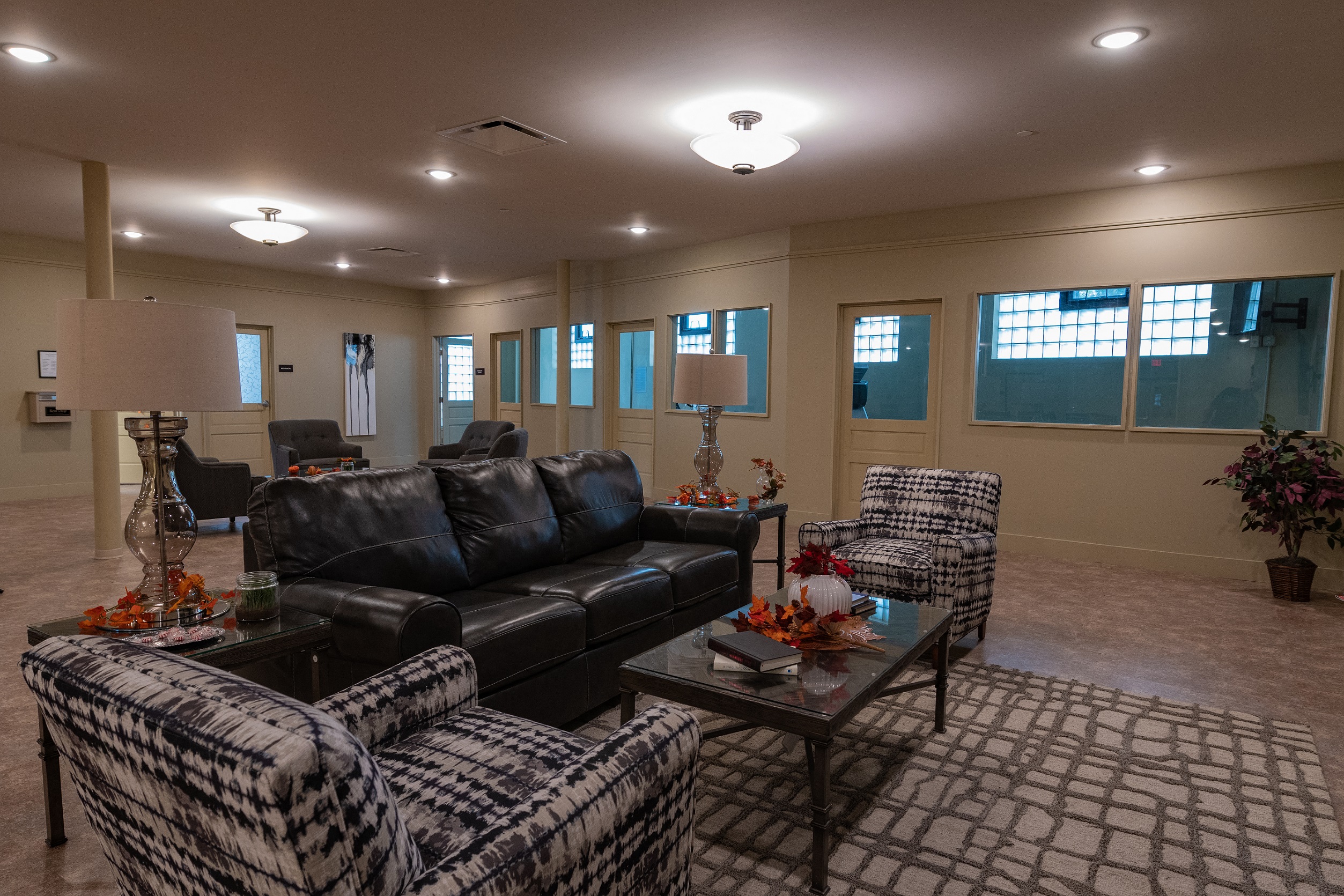 a living room with leather couches and chairs