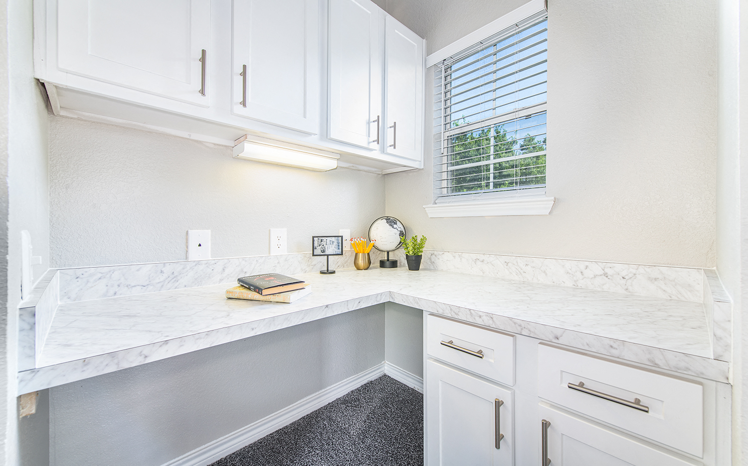a white kitchen with white cabinets and white counter tops