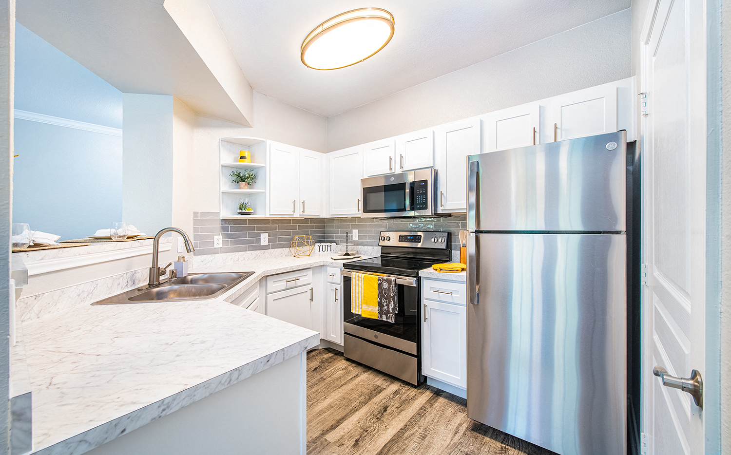 a kitchen with stainless steel appliances and white cabinets