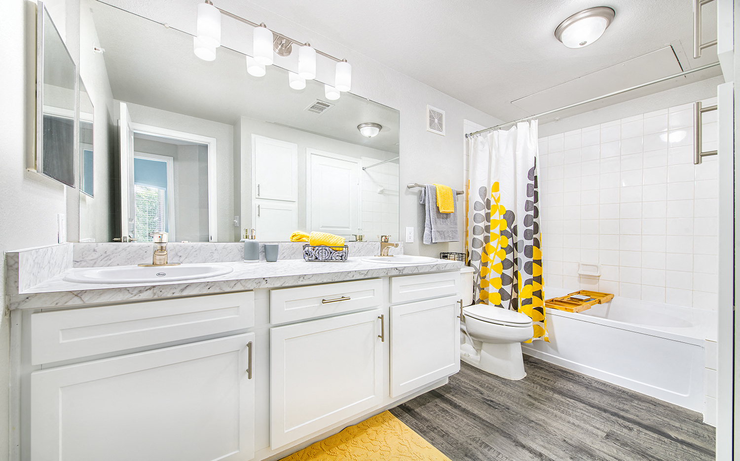 a bathroom with white cabinets and a white toilet and a sink