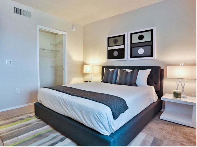 The Highland Apartments bedroom with wall to wall carpet and walk in closet