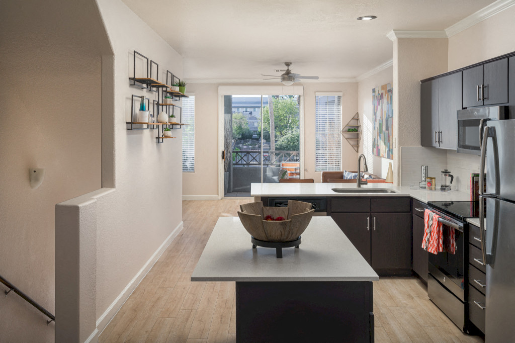 Model kitchen with island and white quartz cabinets
