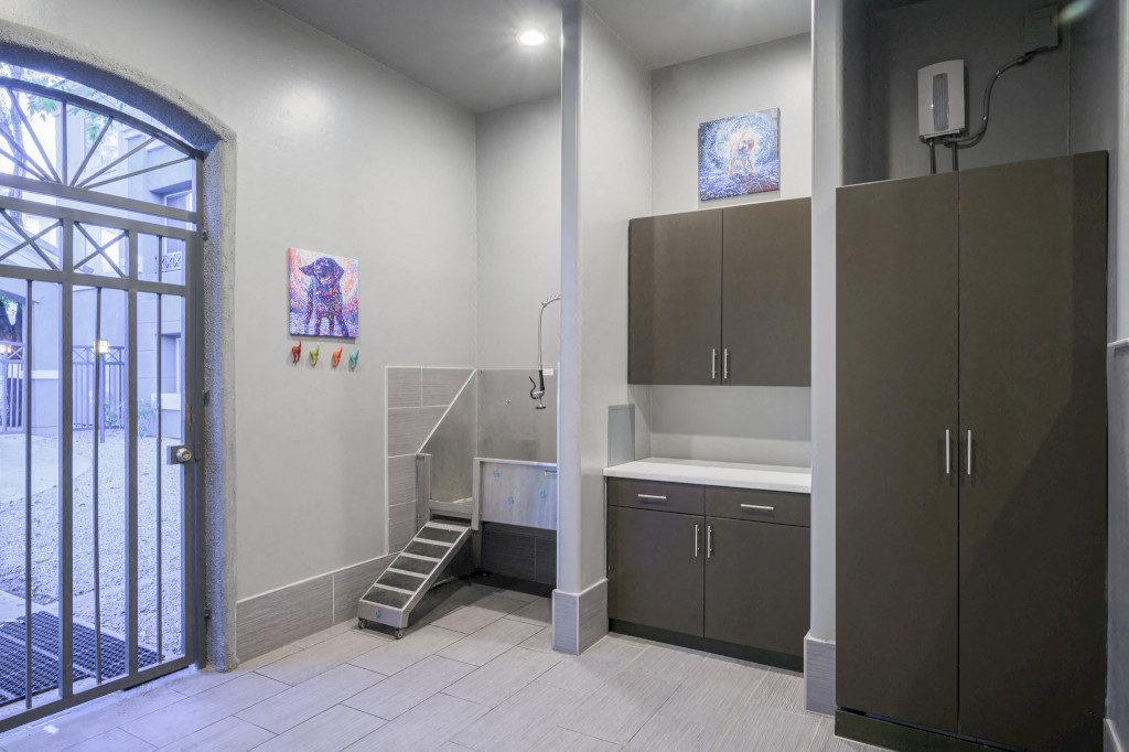 Pet Wash Station with white floors, brown cabinets and door to outside