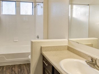 Ingleside Apartments Bathroom with hardwood style flooring and white countertops - Photo Gallery 18