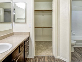 Ingleside Apartments Bathroom  with brown cabinets, beige counter tops and large walk in closet - Photo Gallery 19