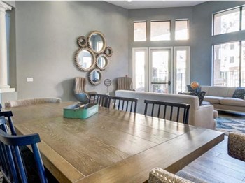 Ingleside Apartments Clubhouse dining table with blue wooden chairs - Photo Gallery 7
