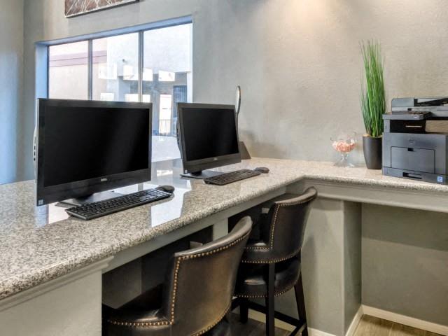 Ingleside Apartments Business Center with two computer screens and grey granite countertops and printer
