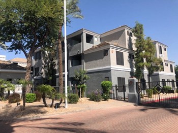 Ingleside apartment building with beige and grey paint and gated entrance - Photo Gallery 3