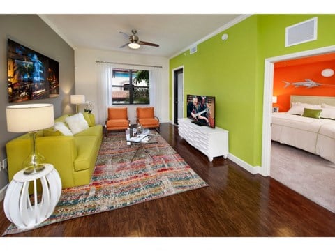 a living room with green and orange walls and a couch