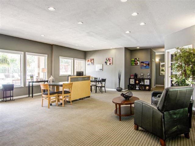 a living room and dining room with a table and chairs