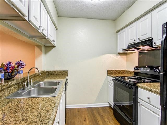 a kitchen with a sink and a stove