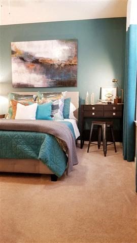 a bedroom with a bed and a desk