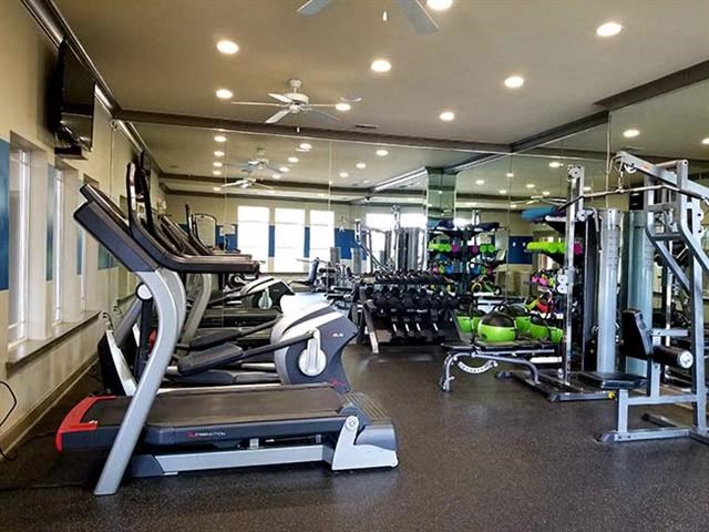 a gym with a lot of machines and weights