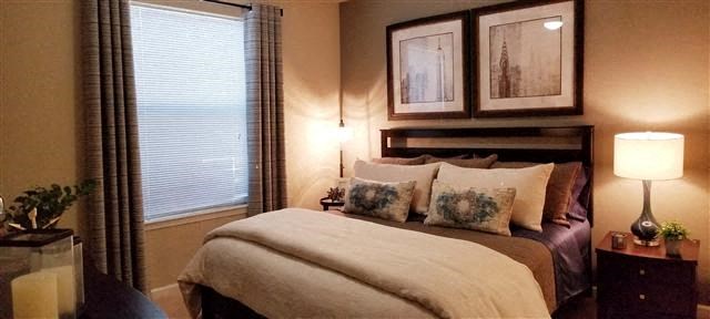 a bedroom with a bed and two pictures on the wall