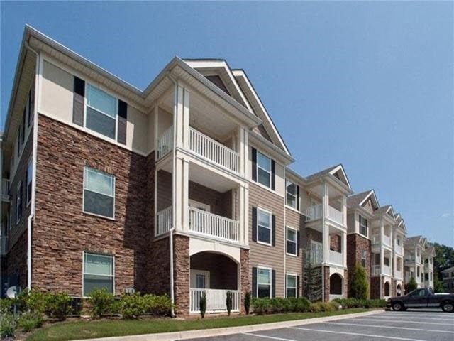 an apartment building with a car parked in front of it