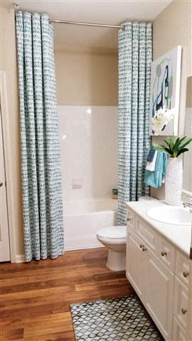 a bathroom with a toilet and a sink and a shower