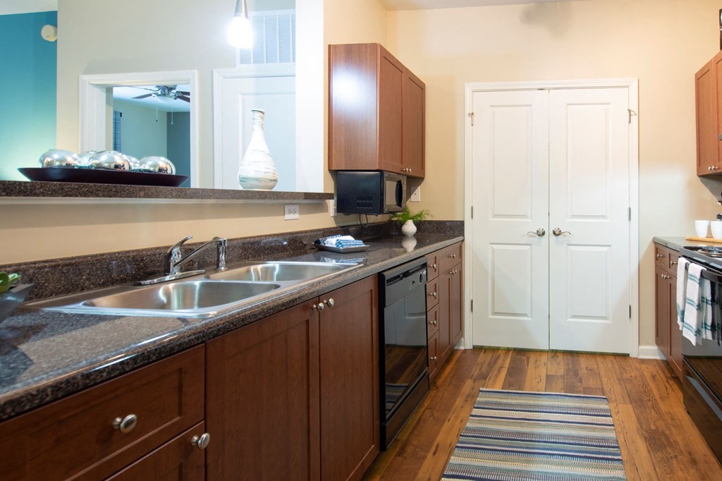 a large kitchen with wooden cabinets and a sink