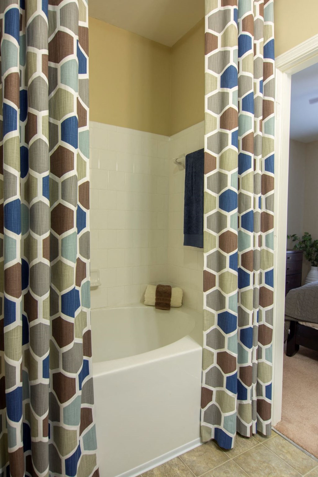 a bathroom with a tub and a shower curtain