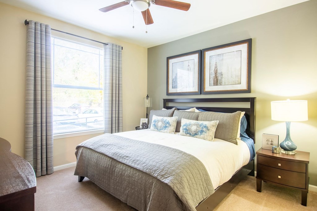 a bedroom with a bed and a ceiling fan