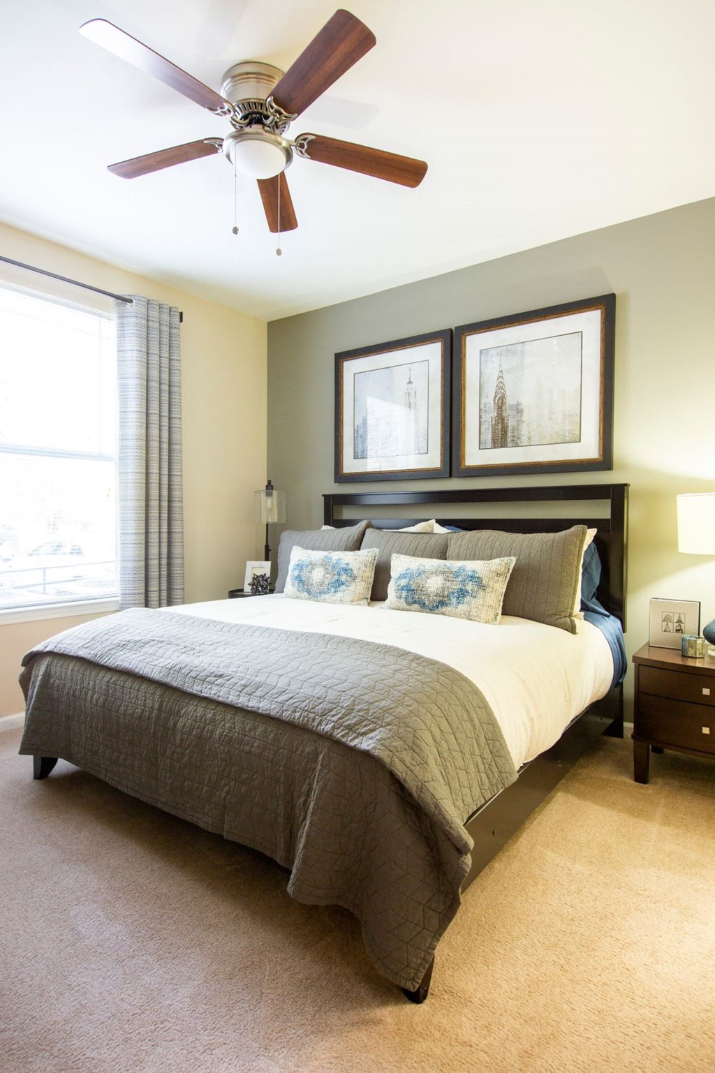 a bedroom with a bed and a ceiling fan