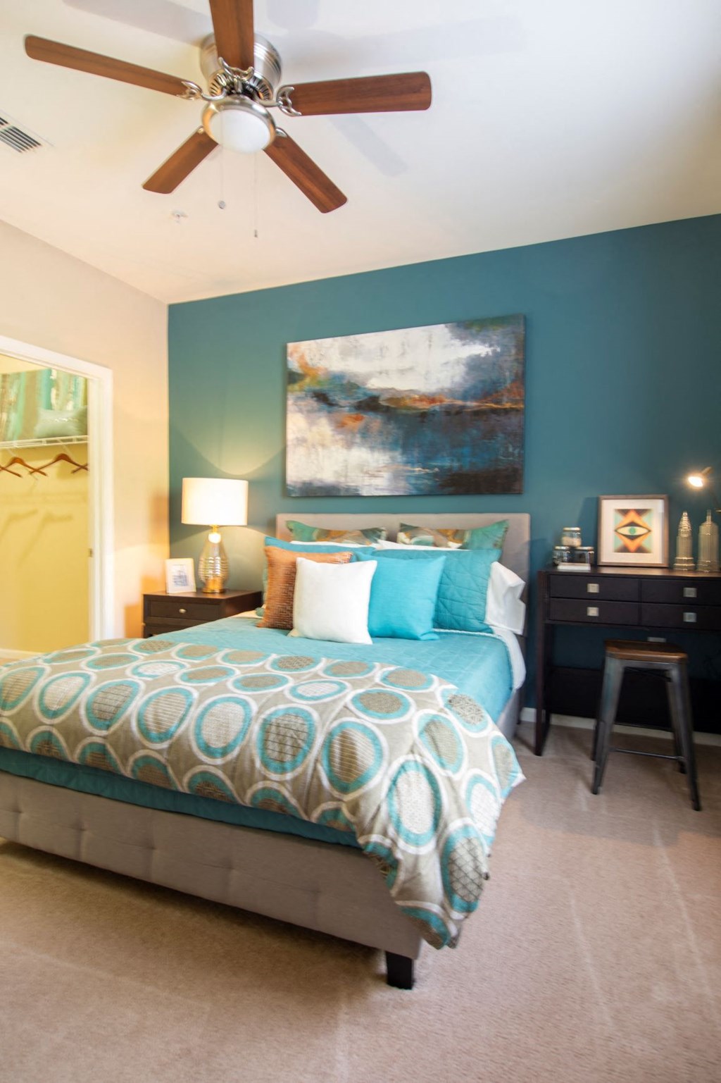 a bedroom with a bed and a ceiling fan