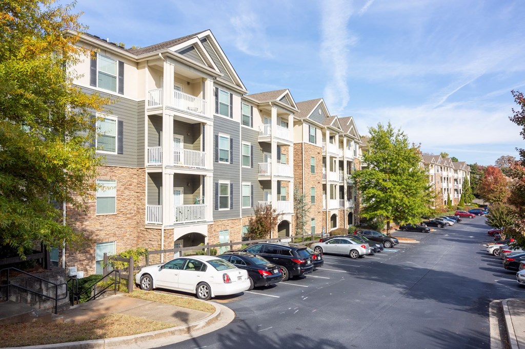 an empty parking lot in front of an apartment building