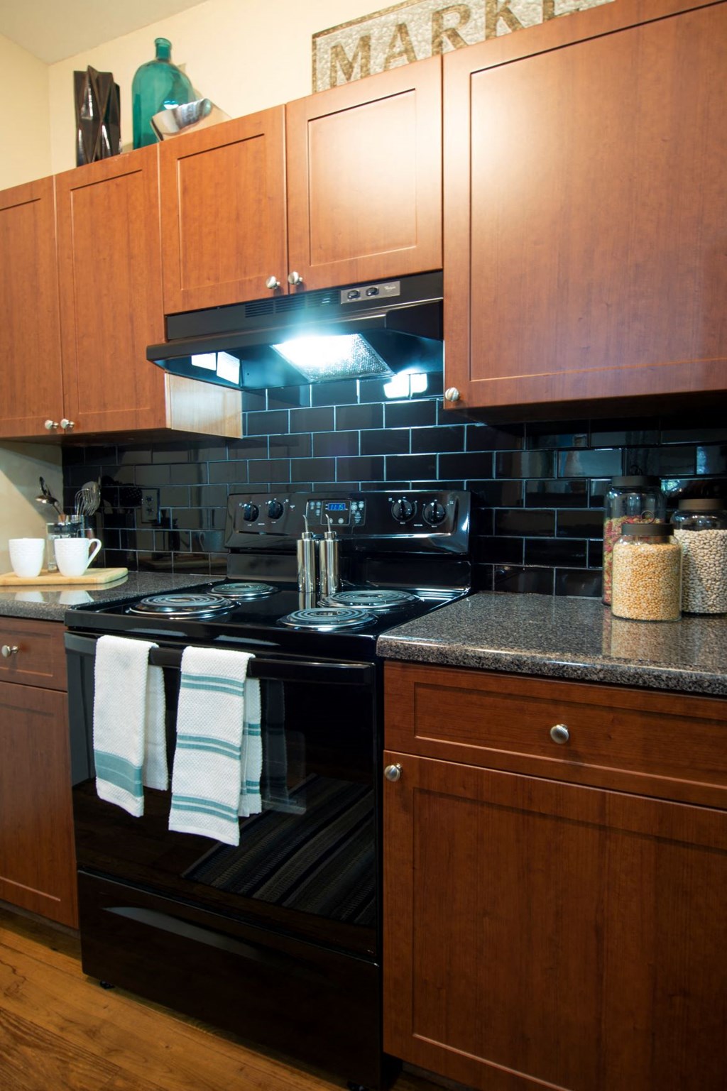 a kitchen with black appliances and wooden cabinets