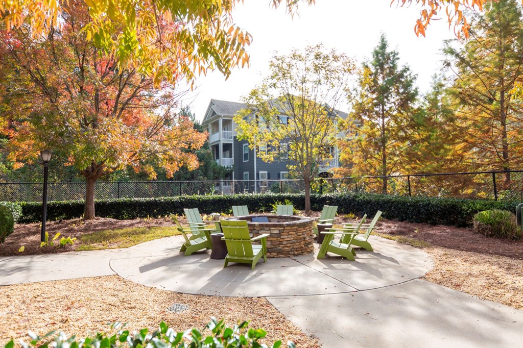 an outdoor patio with chairs and a fire pit