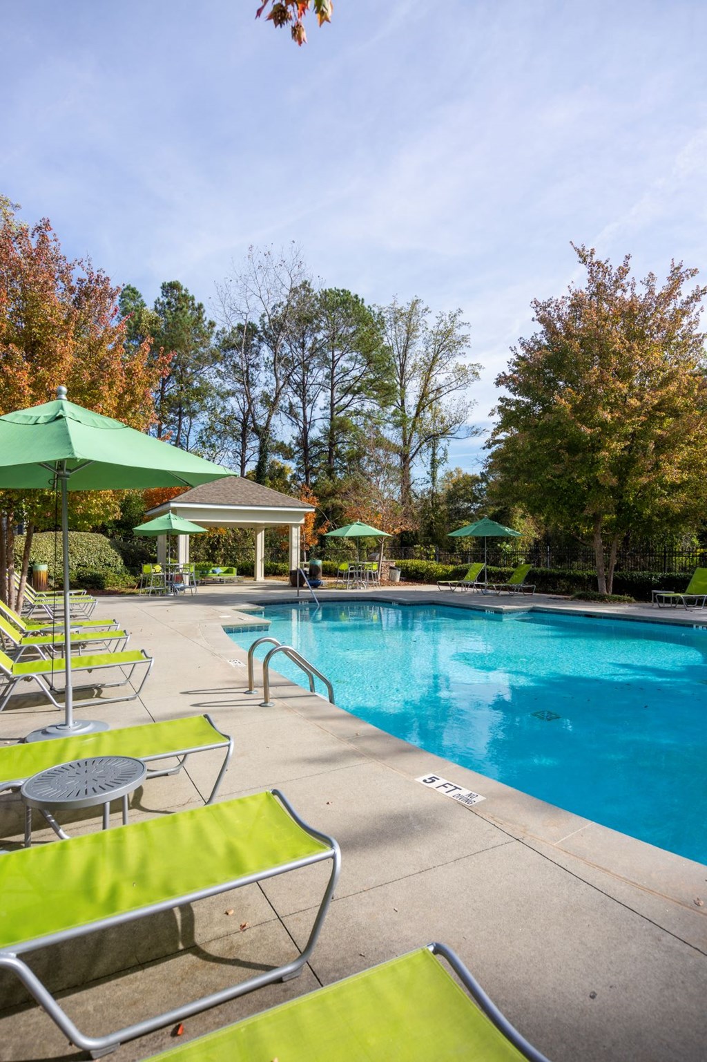a swimming pool with chairs and umbrellas