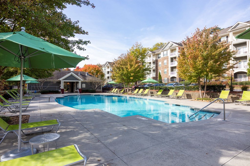 our apartments have a swimming pool with chairs and umbrellas