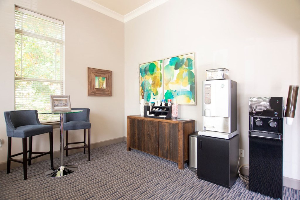a living room with a refrigerator and a table with chairs
