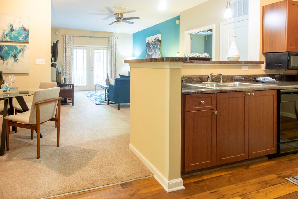 a kitchen and living room with a counter and a sink