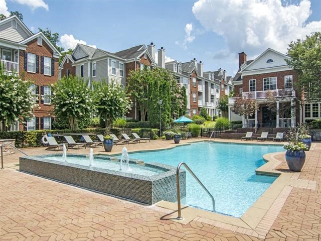 a large swimming pool in front of an apartment building