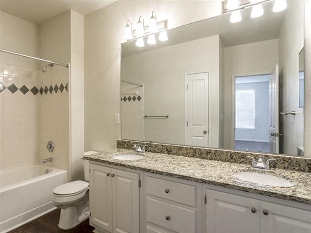 a bathroom with a sink toilet and a mirror