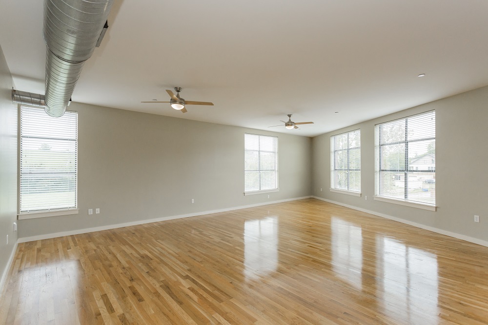 Nashville TN Apartments - Gale Lofts - Spacious Living Room with Wood-Style Flooring and Multiple Windows