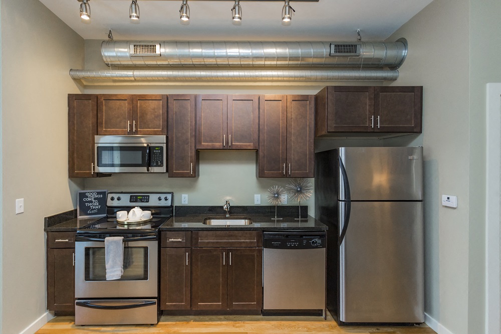 Apartments in Nashville TN - Gale Lofts - Modern Kitchen with Stainless-Steel Appliances and Wood-Style Cabinets