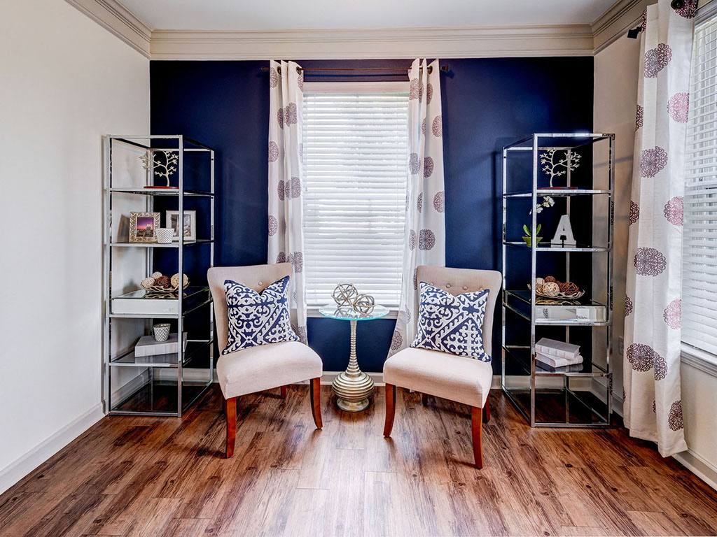 Quaint sitting room with hard wood floors and natural lighting