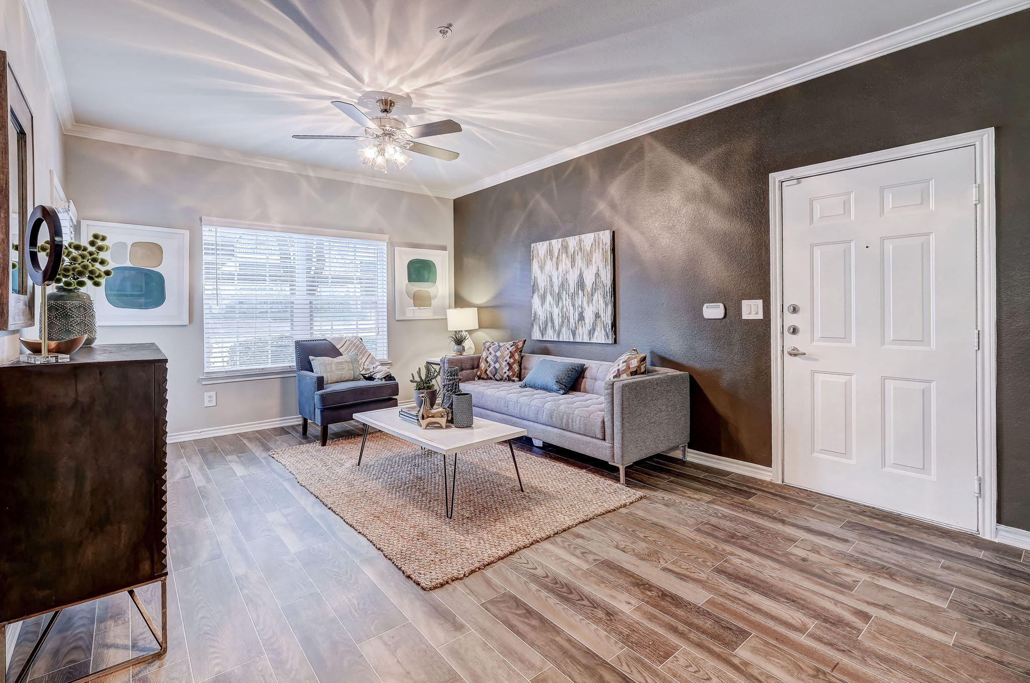 Spacious Living Room with hard wood floors and ceiling fans
