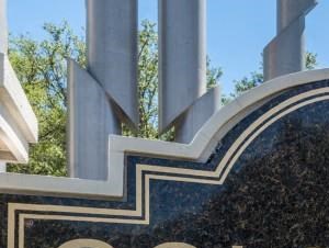 Colonnade Apartments' monument sign with floral surrounding landscape