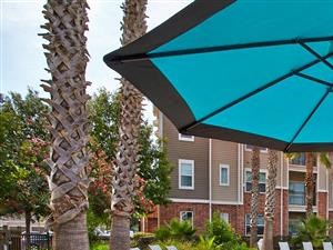 Umbrella covered table and seating with pool view