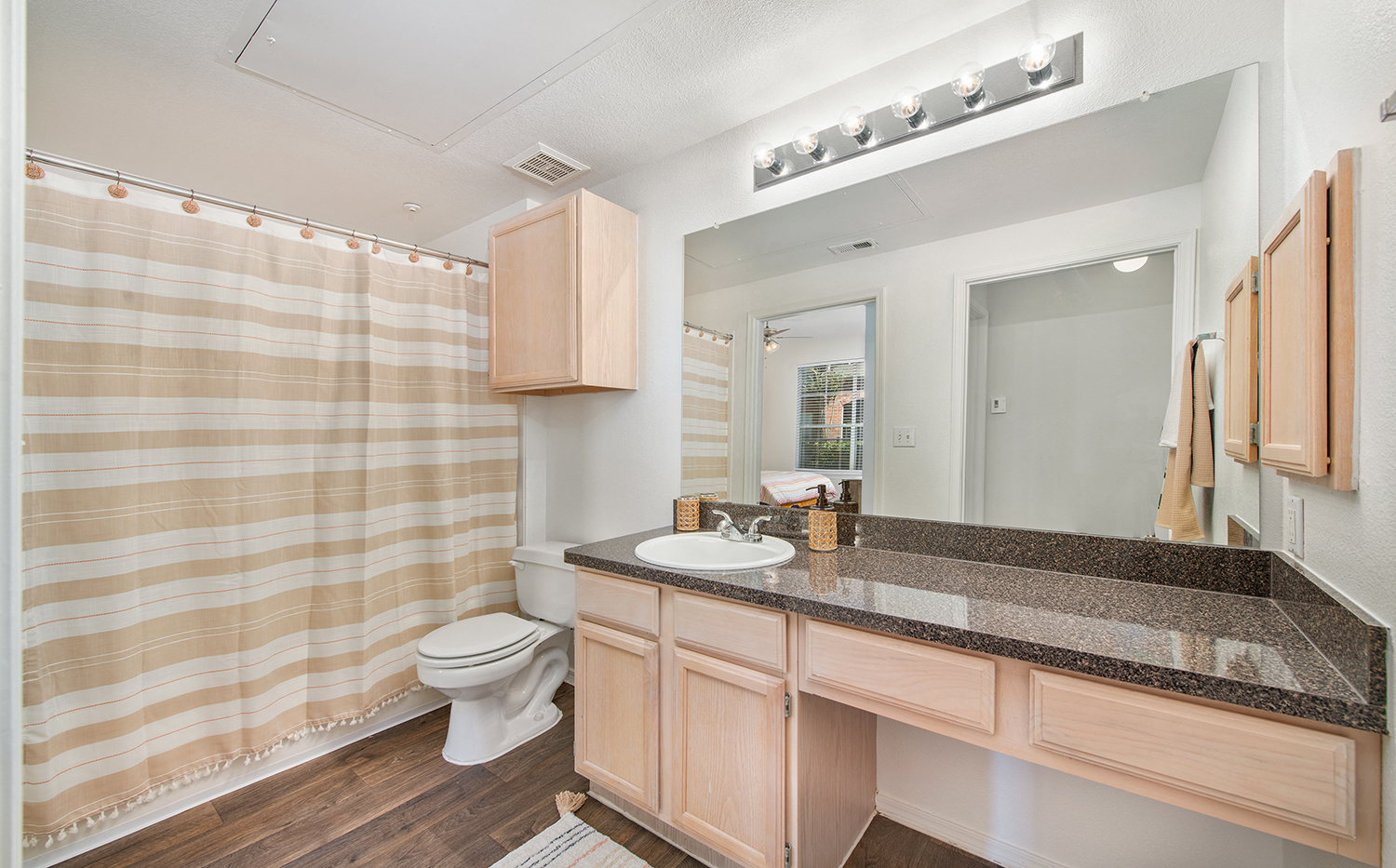 a bathroom with a shower and a sink and a toilet